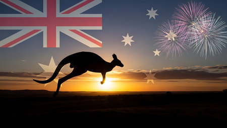 Kangaroo silhouette jumping against fireworks exploding over australian flagの素材