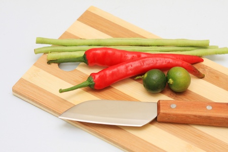 knife cut board and few vegetables