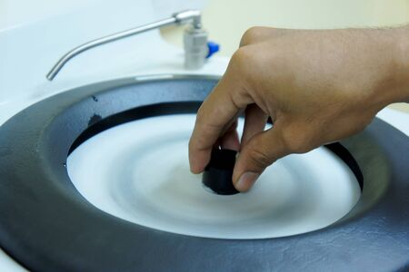 hand sharpening black stone on rotation machineの写真素材