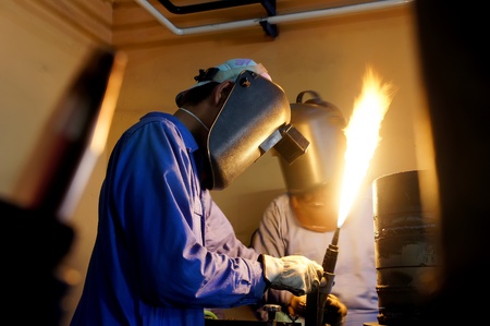two man on fire adjustment to cut the metal pipe