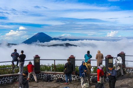 MOUNT BROMO, JAVA-APR 06: Visitors are taking photos of Bromo and Semeru mountain scenery via the highlands Penanjakan. Bromo is very popular tourist destination in East Java, Indonesia on 06 April 2014のeditorial素材