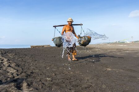 traditional salt mining on kusambar, bali islandの写真素材