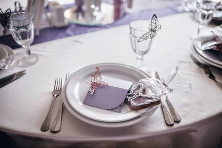 On the wedding table serving plates for guests and decorのeditorial素材