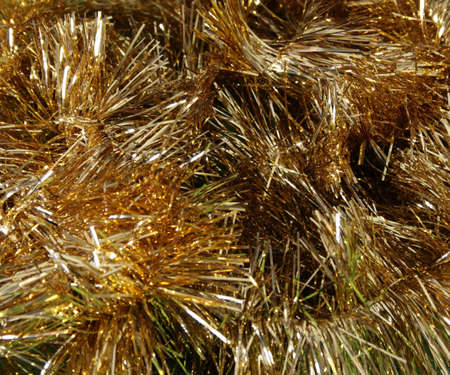 Strings of Gold Tinsel in a heapの写真素材