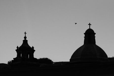 Church steeple silhouette with doveの写真素材