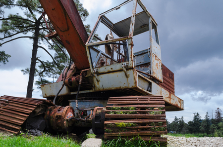 Old rusty crane invaded by mossの写真素材