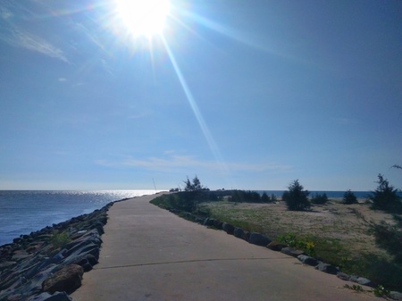 pathway to pier and ocean view with wave breaker stone -image
