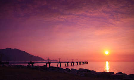 A romantic sunset scene by the seaの写真素材