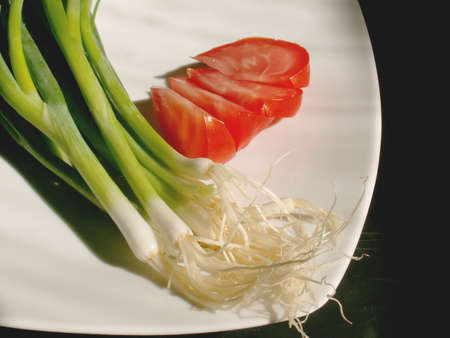 tomato and chive on a plateの写真素材