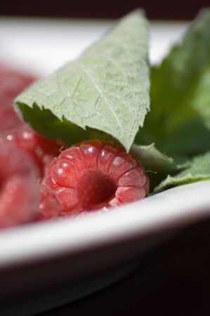 mint and raspberries on a plate