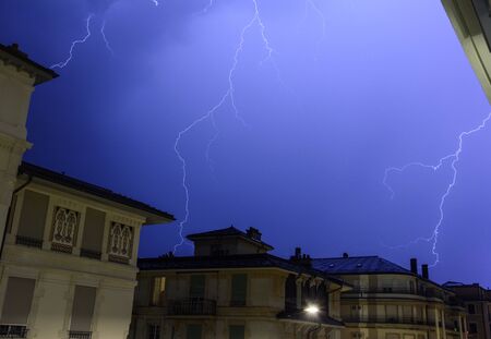 Lightning at night during a storm in the sky of Lausanne, Switzerlandの写真素材