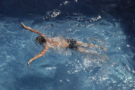 Portrait of boy swimming under water