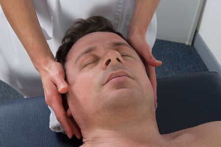 A man having a chinese massage on table massageの写真素材