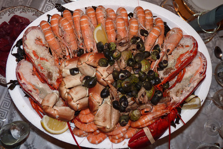 Seafood - Prawns, Squids, Scallops, Mussels, Fillet of Salmon, Crawfish, Greens and Lemonの写真素材