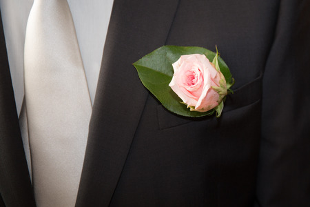 Wedding red rose on a black  suit of the groomの写真素材