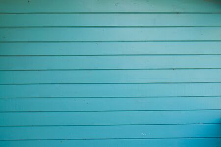Turquoise colored old vintage wood with horizontal boards. Grunge wooden backgroundの写真素材