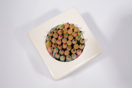 Colorful pencils in pail isolated on white backgroundの写真素材