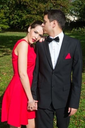 Loving couple in bright clothes dancing on the parkの写真素材