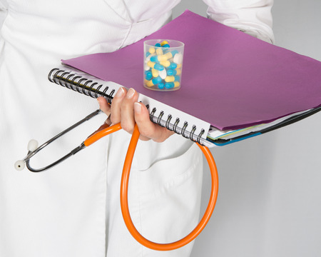 Documents of a doctor, sthetoscope and pillsの写真素材