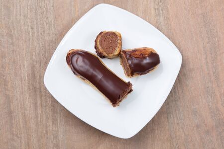 Tasty french chocolate Eclair cut in halfの写真素材