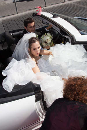 Happy and Lovely bride in a white wedding carの写真素材