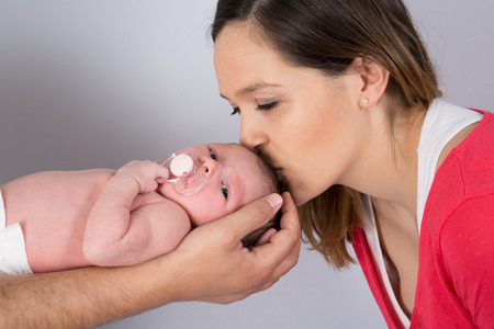 Portrait of a lovely mother with her new born babyの写真素材