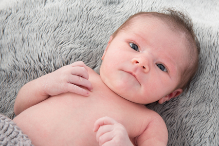 Close up of cute new born baby looking at the cameraの写真素材