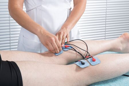 Man with electrostimulator electrodesの写真素材