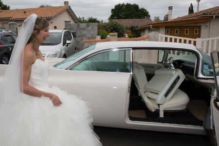 Beautiful bride on wedding car on her wedding dayの写真素材