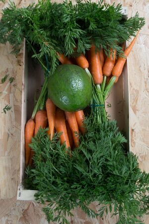 Harvest of organics carrotts on a wood table.の写真素材