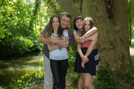 Happy young family with two children outdoors