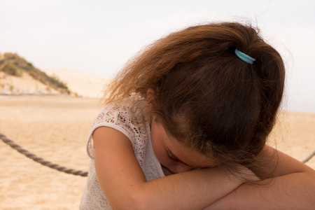 Close up portrait of a ten year old girl, smiling up at the camera. Positive emotionの写真素材