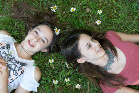 Top view of young girls relaxing on the grassの写真素材