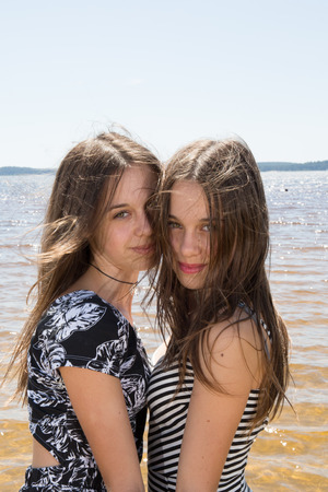 Complicity of two sisters in the summer outsideの写真素材