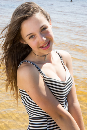 Pretty Young girl  refreshing at the oceanの写真素材