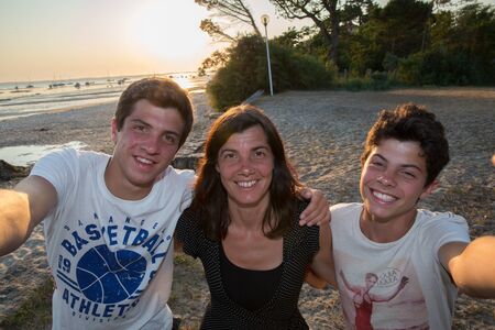 Happy mother with her two son teenager