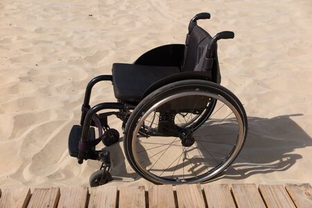 wheelchair in the sandの写真素材