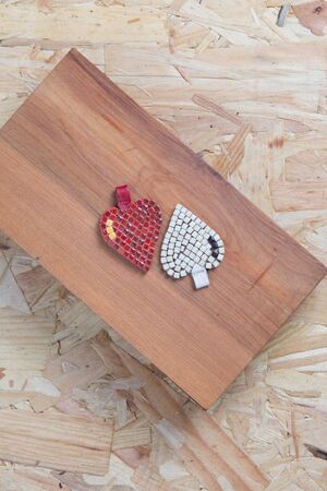 Two hearts , white and red on wooden box