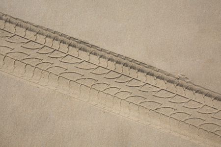 The trace of a tyre in the sand on the beach...の写真素材
