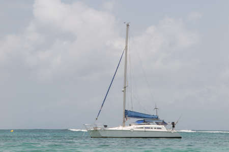 White catamaran on azure water against blue sky, Caribbean Islands