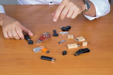 Row of color USB flash drives on wooden  backgroundの写真素材
