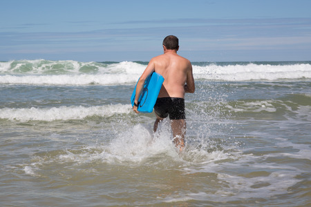 Man having fun at the beach during summertimeの写真素材