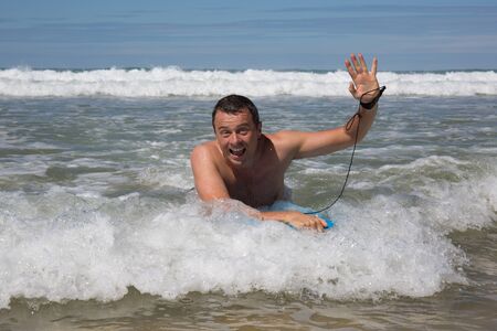 Man having fun at the beach during summertimeの写真素材