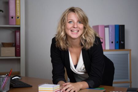 Successful businesswoman portrait at work in bright officeの写真素材