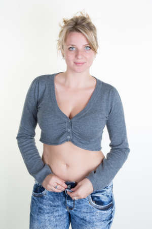 Young sexy blond woman with grey clothesの写真素材