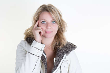 Beautiful blonde woman with white coat isolatedの写真素材