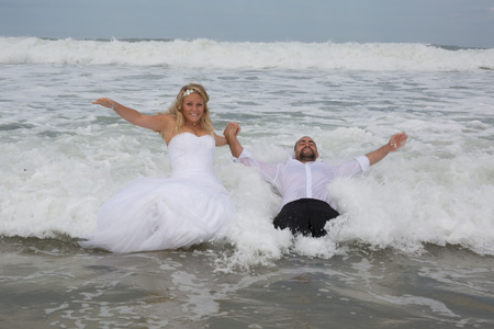 An attractive bride and groom getting married by the beachの写真素材
