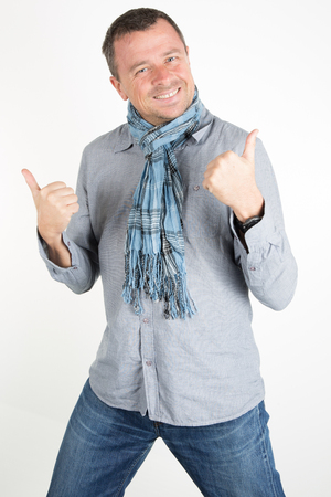 Portrait of a casual man with thumb up, success, happyの写真素材