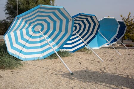 Beach scene. Colorful umbrellas lounge chairsの写真素材