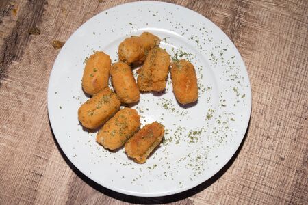 Yummy Fish Sticks in a white plate with herbsの写真素材